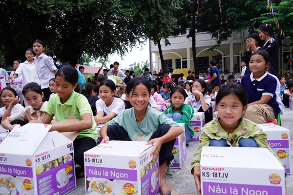 Children receiving rice cookers Phot